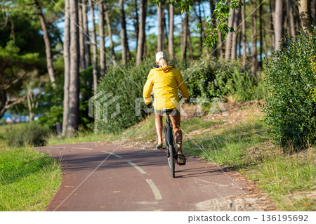 Person riding a bicycle on a cycle path Person riding a bicycle on a cycle path 136195692