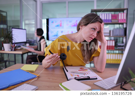 Frustration and focus blend in a busy office environment during a crucial work hour 136195726