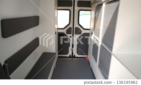 Empty mobile office interior with open doors and bench seating Empty mobile office interior with open doors and bench seating 136195962