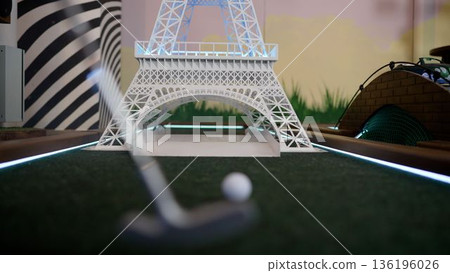Mini golf ball passing through eiffel tower obstacle Mini golf ball passing through eiffel tower obstacle 136196026