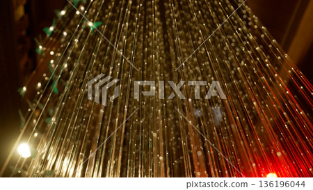 Fiber optic cables transmitting glowing digital network data 136196044
