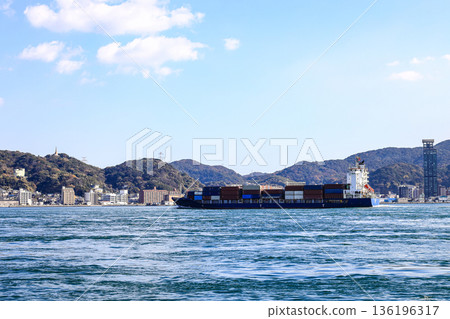 A large ocean liner departed, toward the sea at Kitakyushu, Japan. A large ocean liner departed, toward the sea at Kitakyushu, Japan. 136196317