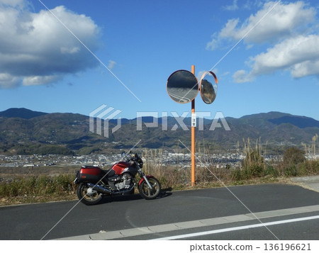 Rider enjoying the scenery on a motorbike Rider enjoying the scenery on a motorbike 136196621