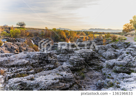 Autumn Canyon Landscape With Rugged Rocks, Golden Trees And Sunset Pathway Autumn Canyon Landscape With Rugged Rocks, Golden Trees And Sunset Pathway 136196633