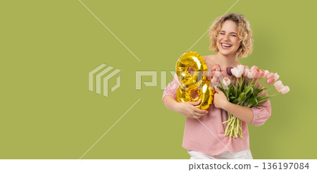 Woman smiles with flowers and balloon for March 8 Woman smiles with flowers and balloon for March 8 136197084