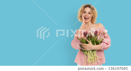 Woman holds flowers and smiles in celebration of Women's Day Woman holds flowers and smiles in celebration of Women's Day 136197085