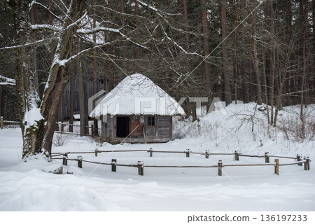 Latvian old wooden house with elaborate wooden columns. Latvian old wooden house with elaborate wooden columns. 136197233
