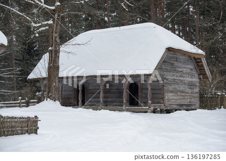 Latvian old wooden house with elaborate wooden columns. Latvian old wooden house with elaborate wooden columns. 136197285