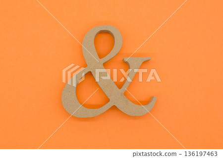 Wooden ampersand & on orange background Wooden ampersand & on orange background 136197463