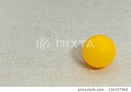 Orange ping pong ball on a white background 136197868