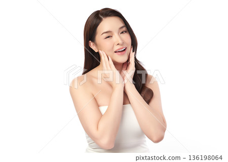 A beautiful young Asian woman with clean, fresh skin against a white background. Skincare, facial treatment, cosmetology, beauty, and spa. An elegant portrait of an Asian woman. 136198064