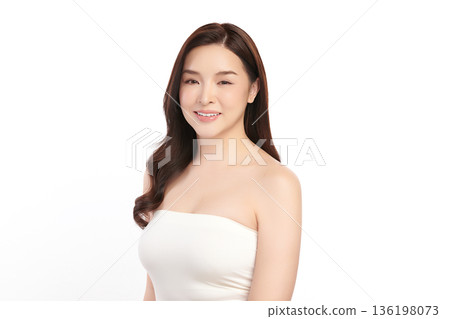 A beautiful young Asian woman with clean, fresh skin against a white background. Skincare, facial treatment, cosmetology, beauty, and spa. An elegant portrait of an Asian woman. 136198073