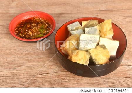 soft fried Japanese tofu dipping with sweet crushed bean sauce on bowl 136199254