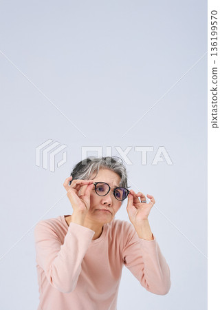 Senior woman suffering from declining eyesight 136199570