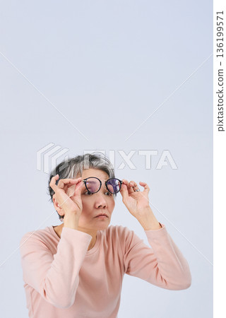 Senior woman suffering from declining eyesight 136199571