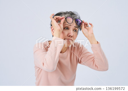 Senior woman suffering from declining eyesight Senior woman suffering from declining eyesight 136199572
