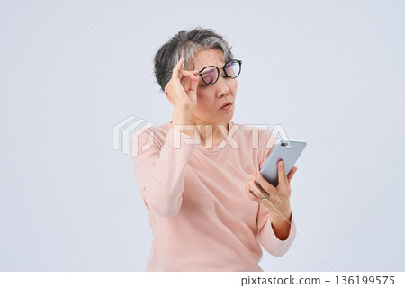 Senior woman suffering from declining eyesight 136199575