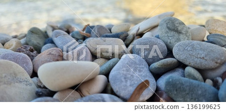 Smooth Rounded Pebbles on Cyprus Sandy Beach Shore 136199625