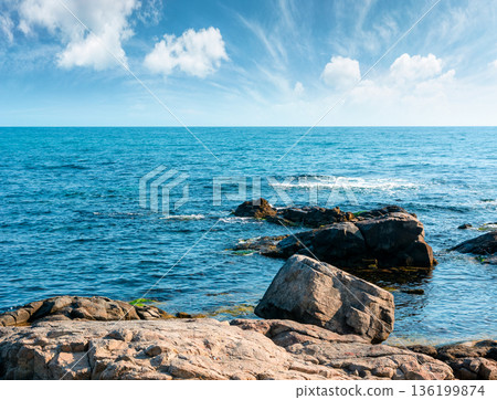 rocky shore of the sea coast under blue sky. beautiful view of coastal bulgaria on a sunny day. resort scenery near sozopol during vacation season in summer. place for vacation, retreats and escape 136199874