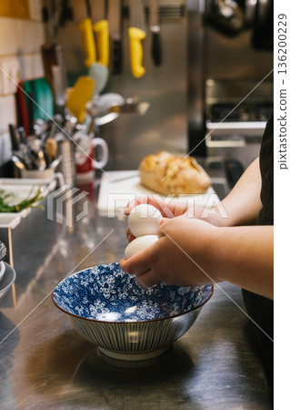 Chef hands holding eggs preparing food in kitchen Chef hands holding eggs preparing food in kitchen 136200229