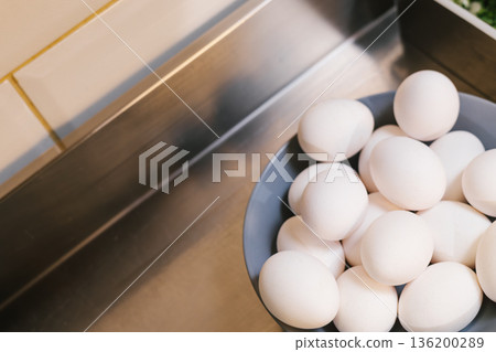 White eggs in bowl on a kitchen counter 136200289