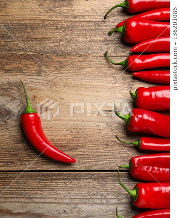 Ripe red chili peppers on wooden table, flat lay. Space for text 136201086
