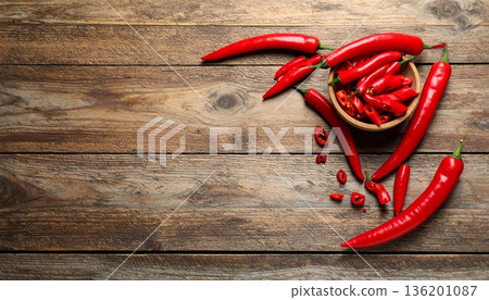 Ripe red chili peppers on wooden table, flat lay. Space for text Ripe red chili peppers on wooden table, flat lay. Space for text 136201087