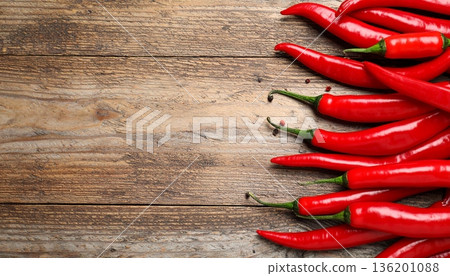 Ripe red chili peppers on wooden table, flat lay. Space for text Ripe red chili peppers on wooden table, flat lay. Space for text 136201088