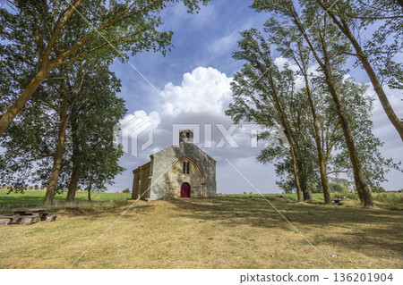 Ancient hermitage standing among trees under a cloudy sky Ancient hermitage standing among trees under a cloudy sky 136201904
