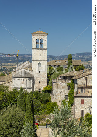 Assisi bell tower rising above historic houses 136202119