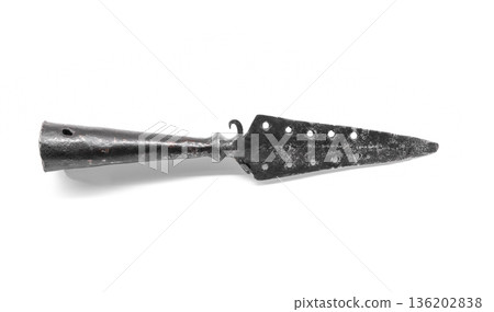 A weathered iron spear tip with a perforated blade 136202838