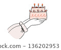 A woman's hand offering a cake 136202953