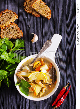 A popular dish of Asian cuisine - soup with shrimps Traditional spicy soup close-up 136203413