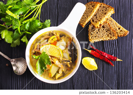 A popular dish of Asian cuisine - soup with shrimps Traditional spicy soup close-up 136203414