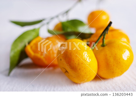 Fresh juicy tangerines on light grey table Fresh juicy tangerines on light grey table 136203443
