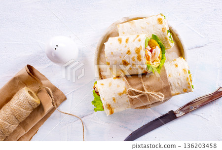 Burrito rolls with ham and cheese on a light background Burrito rolls with ham and cheese on a light background 136203458