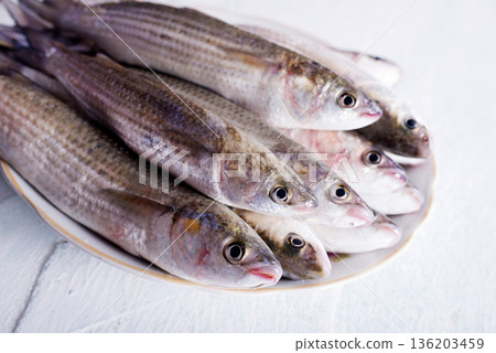 raw fish with spice on plate and on light table raw fish with spice on plate and on light table 136203459