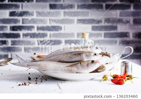 raw fish with spice on plate and on light table 136203460
