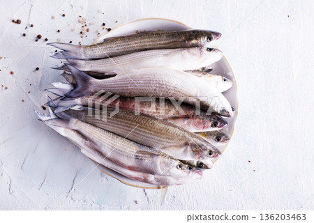 raw fish with spice on plate and on light table raw fish with spice on plate and on light table 136203463