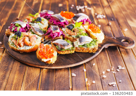Bread Brushetta with fish, salami and cheese. 136203483
