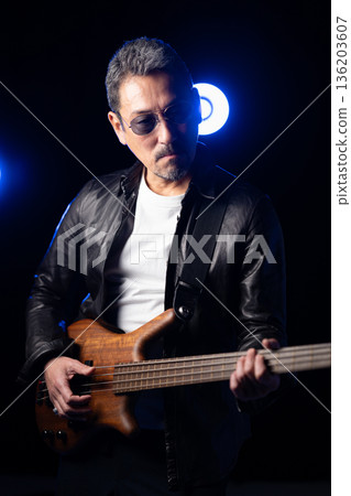 Man playing guitar on stage Man playing guitar on stage 136203607
