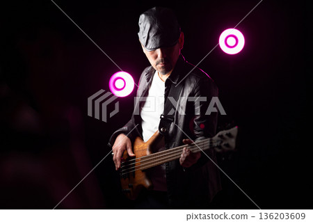 Man playing guitar on stage 136203609