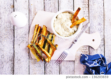 Baked crispy eggplant sticks served with white sauce. Vegetarian healthy dish. Baked crispy eggplant sticks served with white sauce. Vegetarian healthy dish. 136203659