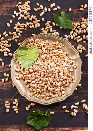 Raw Beans background, white beans on a table Raw Beans background, white beans on a table 136203704