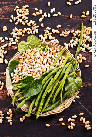 Common bean on darkj table with leaf 136203705