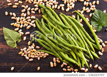 Common bean on darkj table with leaf 136203707