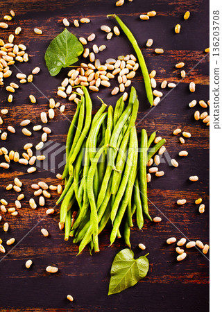 Common bean on darkj table with leaf 136203708