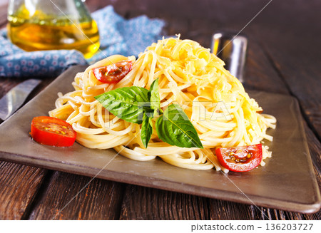 Tasty appetizing classic italian spaghetti pasta with tomato sauce, cheese parmesan and basil Tasty appetizing classic italian spaghetti pasta with tomato sauce, cheese parmesan and basil 136203727