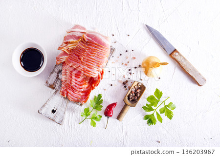 Fresh raw bacon sliced with spices and herbs on a lightr concrete background 136203967