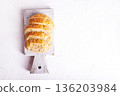 slice of bread on a cutting board 136203984